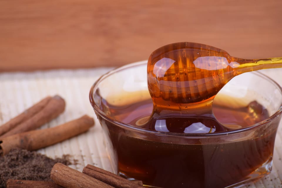 Bowl of honey on dipper for medicinal use
